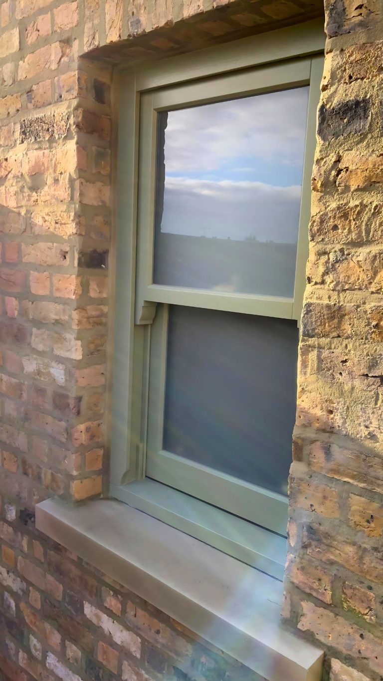 Farrow and Ball green painted sash window with sash horns